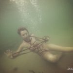 Tied young model under the water Salty ropes